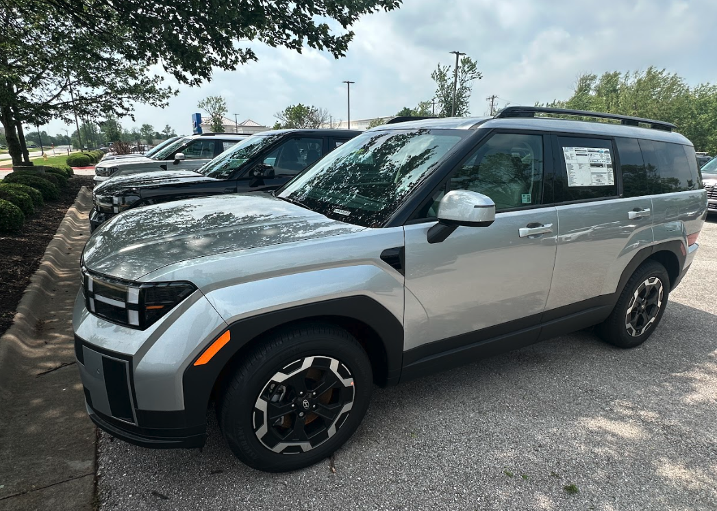 Silver Hyundai SUV parked in dealership lot with Top Safety Pick+ rating window sticker